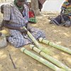 A HSNP beneficiary engaging in making of brooms for selling, Turkana